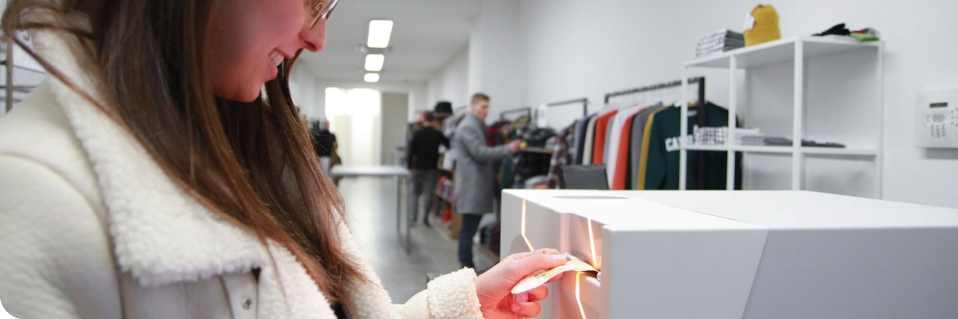 A photo of a woman using a Consillion cash machine