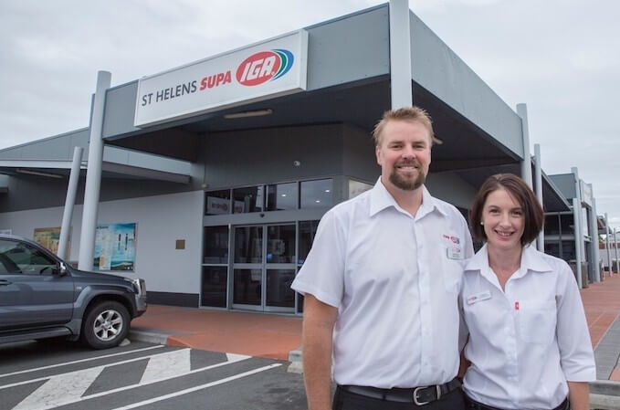 A photo of a man and woman in front of Supa IGA St Helens